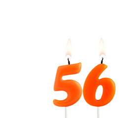 Lit birthday candle - Candle number 56 on white background.