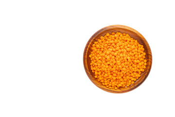 Lens culinaris - Organic unshelled red lentils in a wooden bowl.