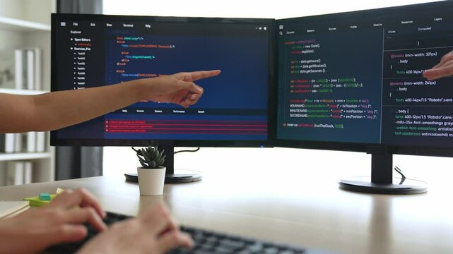 Slow motion back end software developer engineer for computer programming working together on debugging writing computing code, solving complex algorithms display on monitor in office. Burgeoning