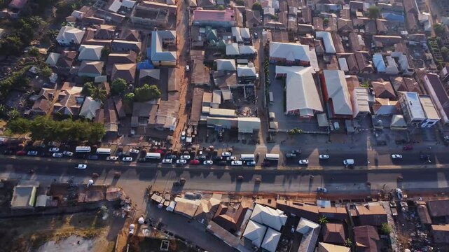 Aerial of a long row of cars in a traffic jam near the slums of Abuja, Nigeria