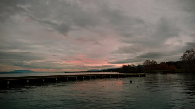 Timelapse of fire sky at sunset over Lake Geneva in Rolle Switzerland