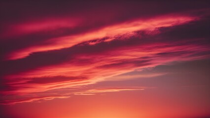 Obraz premium Dramatic sunset sky background with vibrant shades of red pink and orange evoking a warm and romantic atmosphere