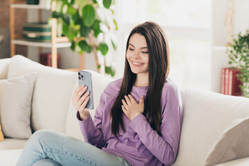Photo of lovely young teen girl video call talking dressed violet garment spacious house bright indoors room