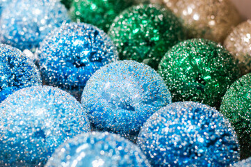 Close-up of Christmas blue, green, and sparkling balls lined up in a row