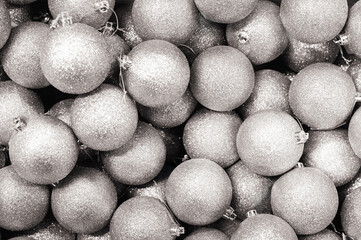 Background of Christmas, New Year silver balls with glitter, top view. Textured background