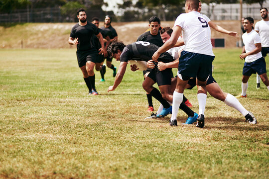 Sports, outdoor and team of rugby players at match, training or competition with opponent. Tackle, fitness and men athletes playing game for practice, workout or exercise of skill on field at stadium