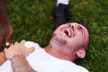 Man, screaming and shoulder pain with sports injury on grass field for emergency, medical attention or accident. Male person, athlete or rugby player shouting with joint dislocation for foul or game
