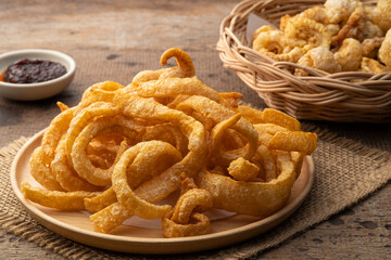 Crispy pork rinds,deep fried pork skin in wooden plate,yummy snacks food.
