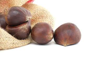 Close-Up of Fresh Chestnuts in Burlap Sack on White Background