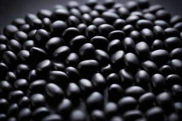 a close up of a pile of black beans on a table
