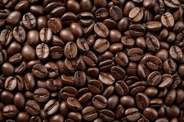 Fototapeta premium a close up of a pile of coffee beans with a lot of coffee beans