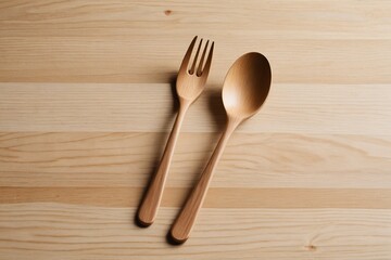there are two wooden spoons and a fork on a table