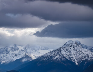 Snow-Capped Peaks Beneath Stormy Skies