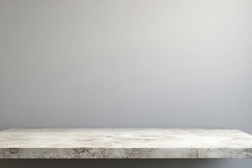 Minimalistic grey wall with a textured countertop.