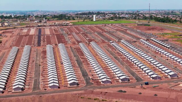 Aerial pan view of popular housing under daylight.