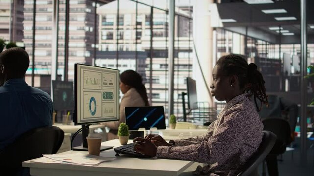 Female manager engaged in budget analysis and strategy development at her workstation, supporting objectives for company growth and collaboration. Strategizing business goals. Camera B.
