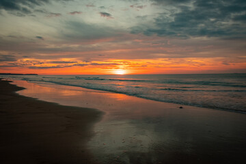 Beautiful sunset over the ocean, capturing serene waves and vibrant twilight sky colors on the coast.