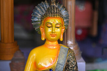 colorful Buddha sculpture sitting in meditation.