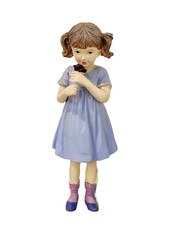 A little girl is holding a flower in her hand