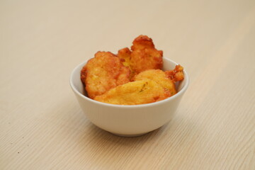 Corn croquettes in a bowl on a wooden table