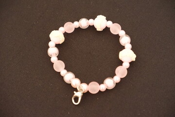 A beaded bracelet on a black surface