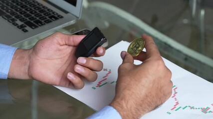 Indian man using bitcoin crypto currency hardware wallet to send funds for safety and protection. Risk management, Custodian, Block chain technology. Trading, investing and finance.