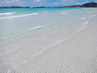 On a sunny day, the beach has white sand and clear turquoise water Whitehaven Beach is on Whitsunday Island, Queensland, Australia