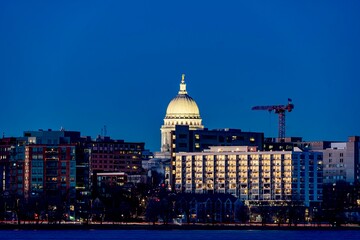Downtown Madison, WI and the Wisconsin State Capitol Building behind Lake Monona at Twilight