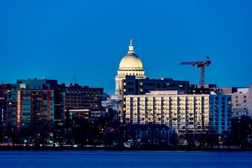 Downtown Madison, WI and the Wisconsin State Capitol Building behind Lake Monona at Twilight