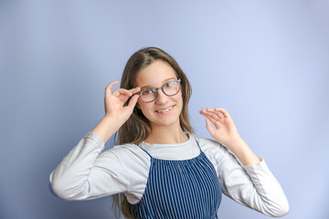 adorable smiling child looking at camera in eyeglasses