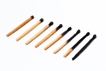stages of wooden match sticks burn on isolated white background