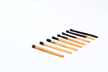 stages of wooden match sticks burn on isolated white background