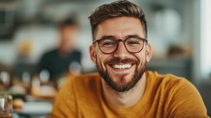 Obraz premium Cheerful and Confident Looking Man Smiling and Dining at a Cozy Customer Focused Restaurant Establishment