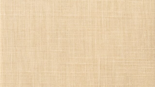 Jute hessian sackcloth canvas sack cloth woven texture pattern background in yellow beige cream brown color
