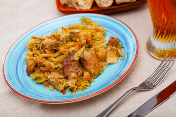 Home style stew of cabbage with pieces of pork. Traditional Ukrainian cuisine