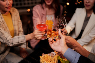 Party Celebrate whiskey at a friendly party in a restaurant. Night.
