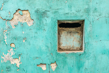 Turquoise Concrete Wall with a Small Window