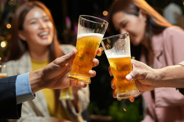 food and drink male friends are happy drinking beer and clinking glasses at a bar or pub.