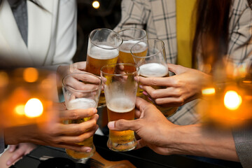 food and drink male friends are happy drinking beer and clinking glasses at a bar or pub.