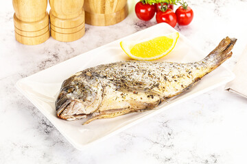 Baked Dorado fish served lemon