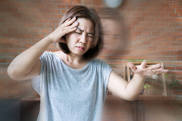 Asian woman experiencing sudden dizziness, headache, and loss of balance due to ischemic stroke