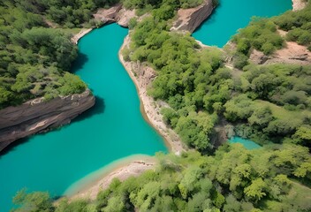 Obraz premium Aerial view of a turquoise river flowing between lush green foliage