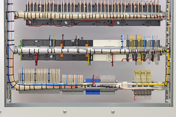 The reverse side of the electrical switchboard. The connected wires are tied with plastic ties.