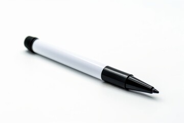 A black and white pen rests on a clean surface under soft lighting