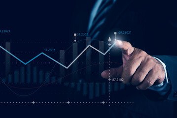 Businessman pointing at growth graph and business concept. Graph and chart. Business strategy development and growing growth plan concept.