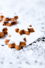 Christmas cookies (cinnamon stars) on bright background. Close up.