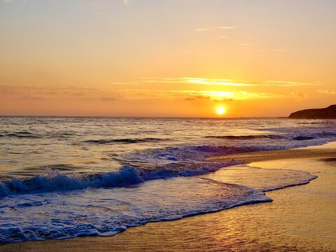 Sun setting over ocean
