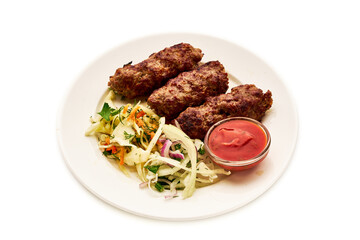 A plate of meat and vegetables with a red sauce