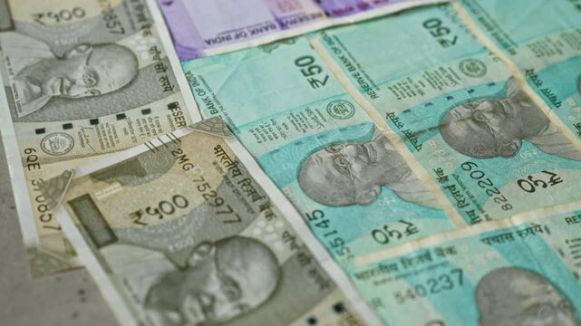 Indian banknotes in various denominations arranged closely, showcasing the vibrant colors and designs of rupee currency notes.