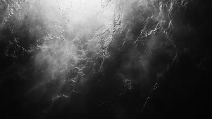 Abstract black and white image of smoke swirling in a dark background